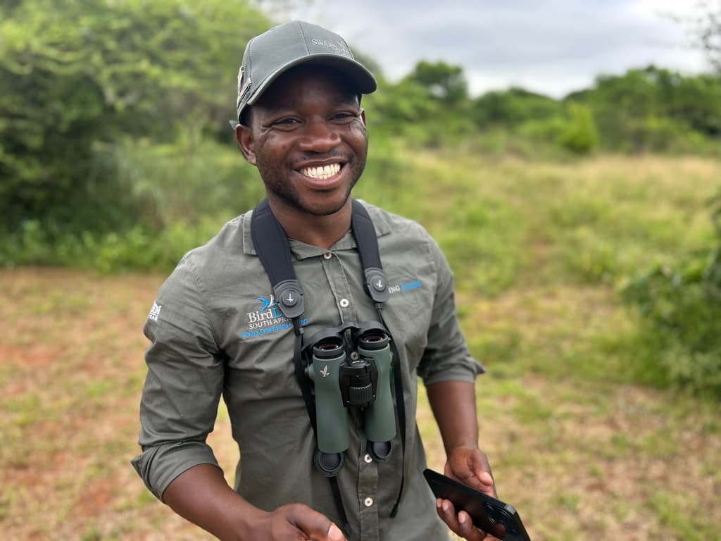 BirdLife South Africa field guide with binoculars