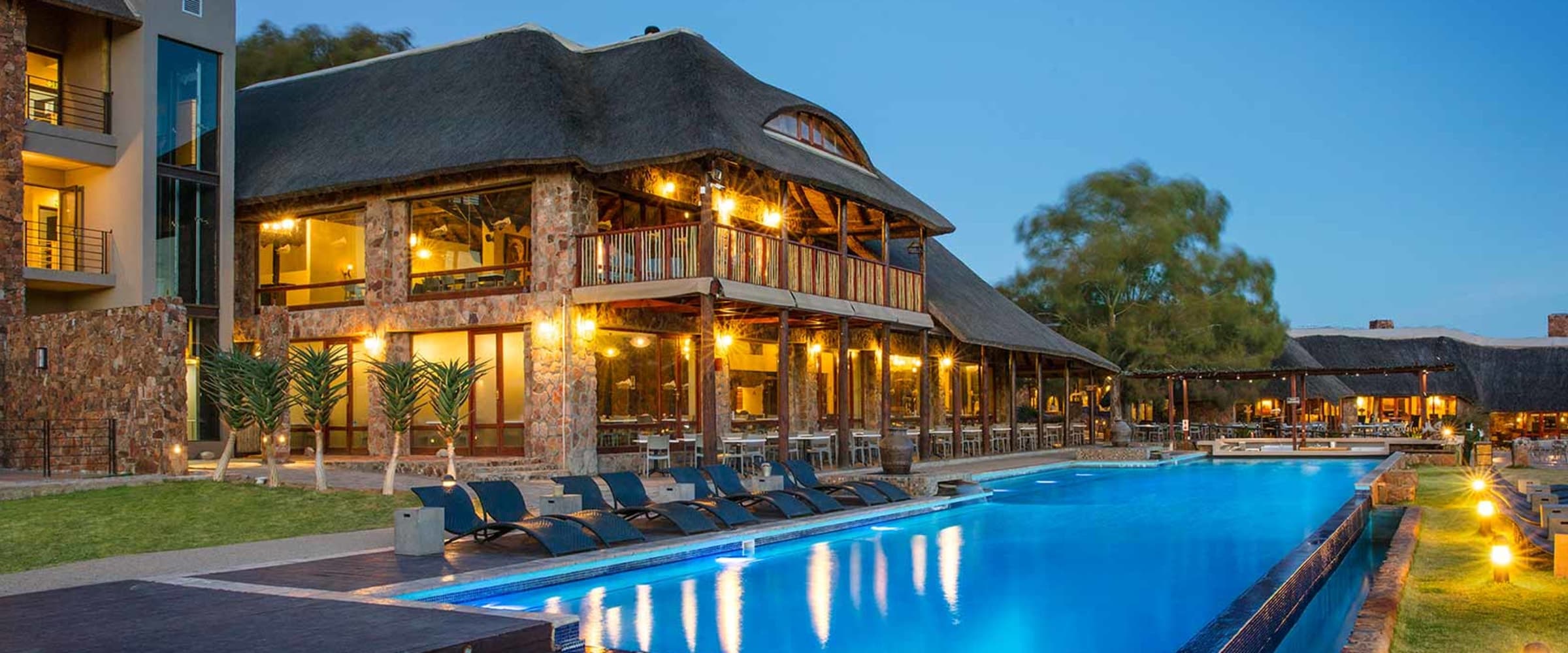 Aquila Private Game Reserve lodge and pool at dusk, South Africa