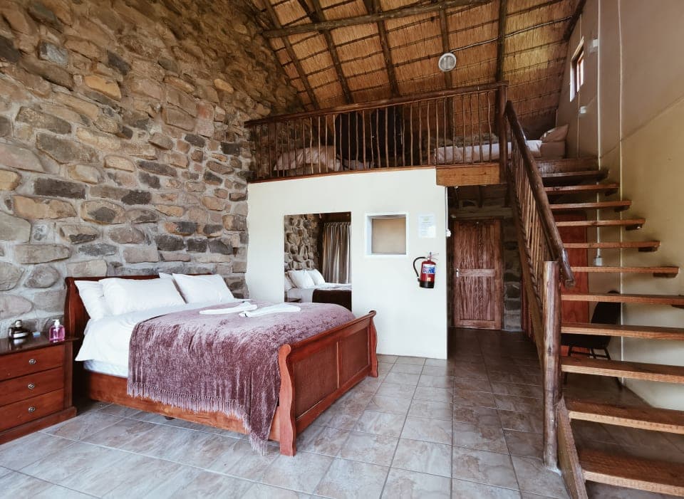 Stone-walled bedroom with loft at Ntsikeni Lodge