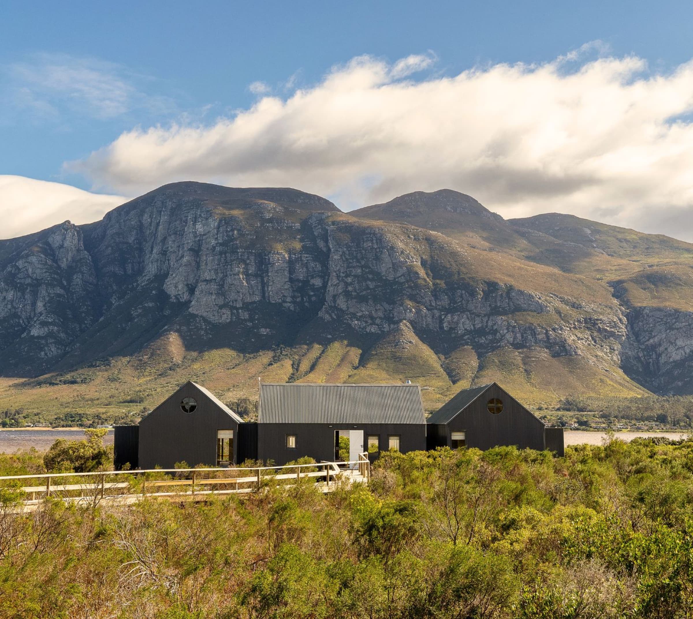 Coot Club Stern Boathouse With mountain backdrop